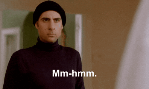 Man in Black Turtleneck and Beanie Says Mm-Hmm