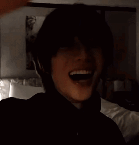 Man in Black Turtleneck in Front of Bed