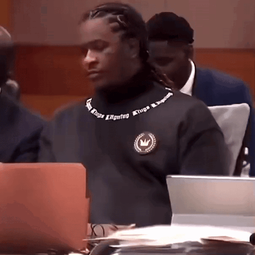 Man In Black Turtleneck With Atripa On Neck GIF