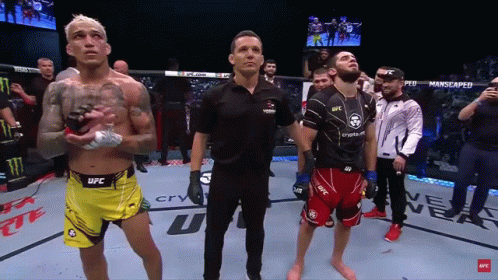 Man In Black UFC Shirt Holding Arm Up GIF