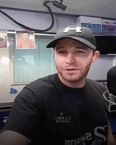 Man in Black Under Armour Hat and Shirt