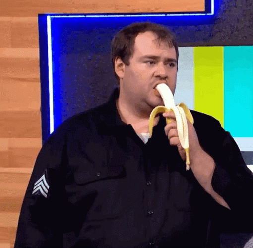 Man In Black Uniform Eating Banana GIF