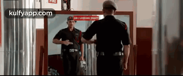 Man In Black Uniform Looking In Mirror GIF