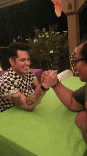 Man in Black White Checkered Shirt Arm Wrestling