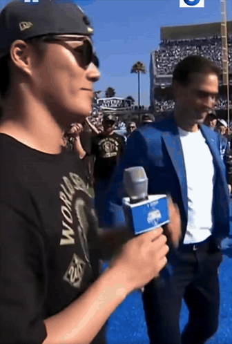 Man in Black World Shirt Holding Microphone