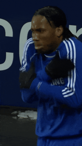 Man in Blue Adidas Shirt in Front of Number 3