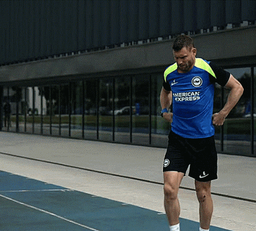 Man in Blue American Express Shirt on Track