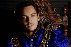 Man in Blue and Gold Costume Sitting in Wooden Chair