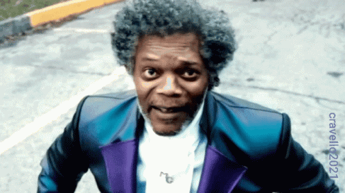 Man in Blue and Purple Suit on Street