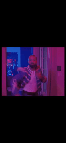 Man in Blue and White Jacket Dancing in Purple Lights