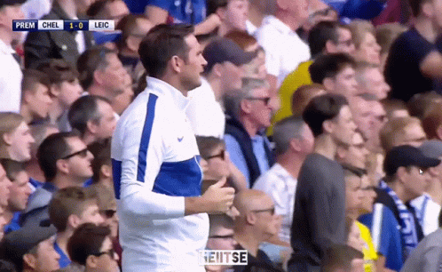 Man In Blue And White Nike Jacket Watching Soccer Game GIF