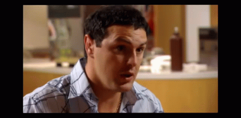 Man in Blue and White Plaid Shirt Making Funny Face