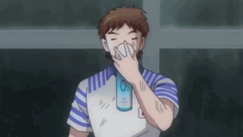 Man in Blue and White Shirt Covering Nose