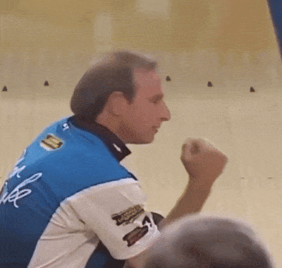 Man in Blue and White Shirt With Sticker Saying A