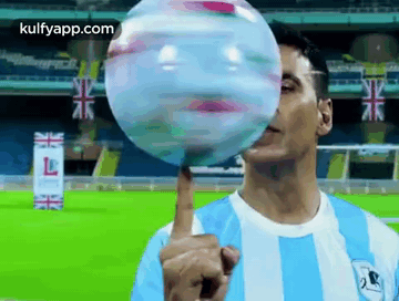 Man in Blue and White Striped Shirt Blowing Bubble With Fingers