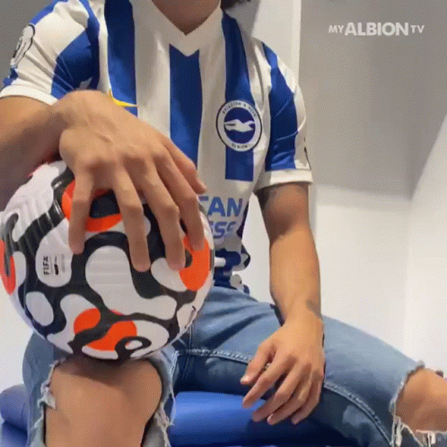 Man In Blue And White Striped Shirt Holding Soccer Ball GIF