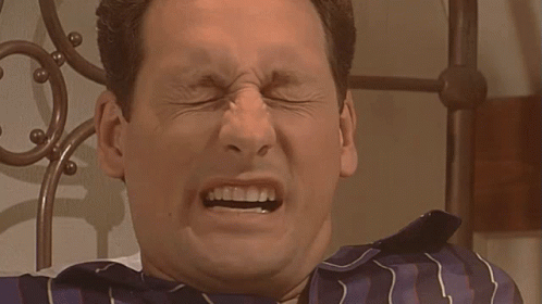 Man in Blue and White Striped Shirt Making Funny Face