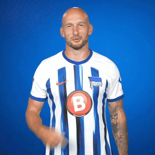Man in Blue and White Striped Shirt With Letter B