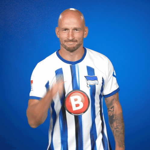 Man in Blue and White Striped Shirt With Letter B