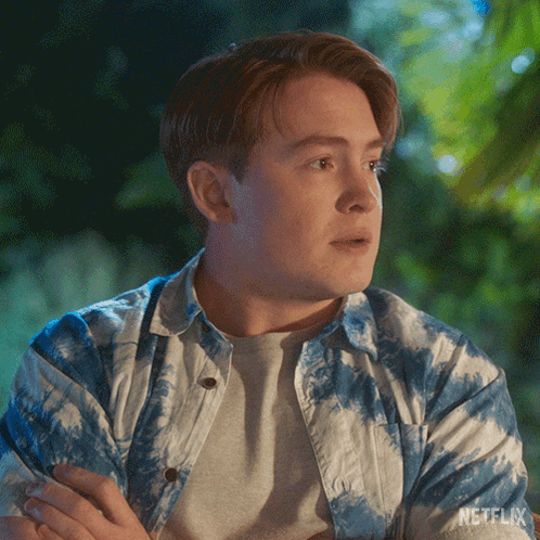 Man in Blue and White Tie Dye Shirt Crossed Arms