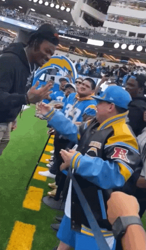 Man in Blue and Yellow Jacket With Letter R