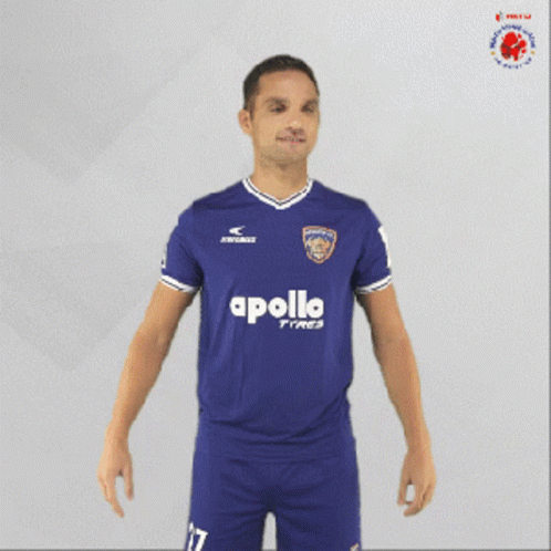 Man in Blue Apollo Tires Jersey Holding Soccer Ball