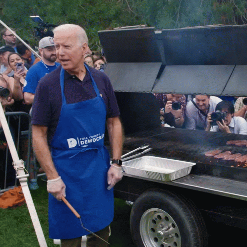 Man in Blue Apron Grilling