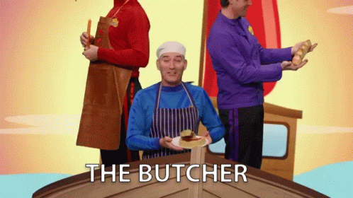 Man in Blue Apron Holding Plate with Butcher Text