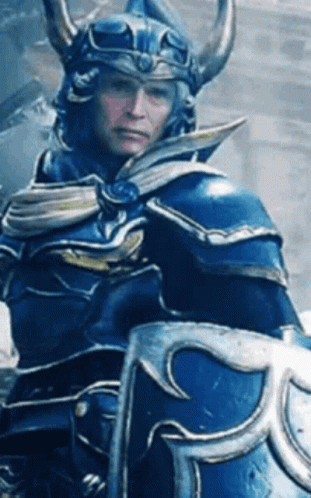 Man in Blue Armor and Helmet Holding Shield