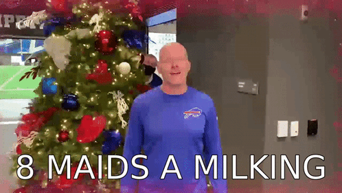 Man in Blue Bills Shirt by Christmas Tree