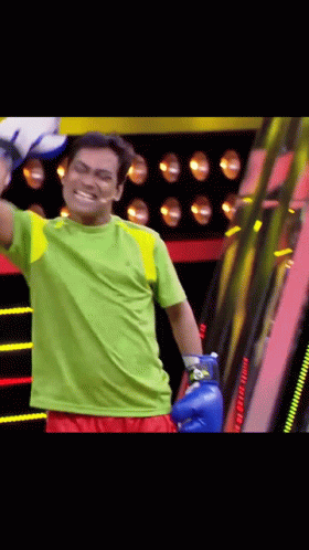 Man in Blue Boxing Gloves and Green Shirt
