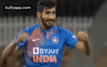 Man in Blue Byju's India Jersey Dancing on Soccer Field