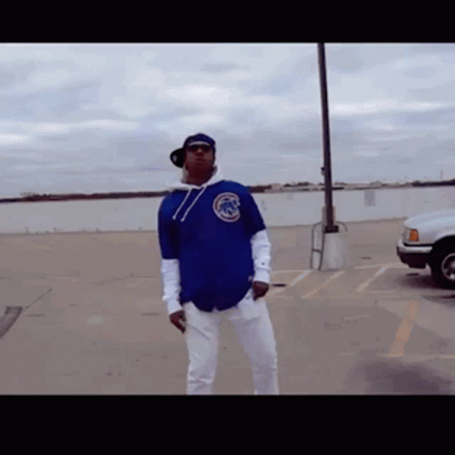 Man in Blue Chicago Cubs Jersey Standing in Parking Lot
