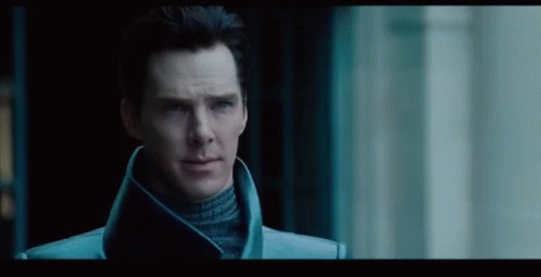 Man in Blue Coat and Turtleneck in Dark Room
