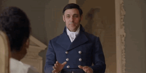 Man in Blue Coat Holding Hands Up