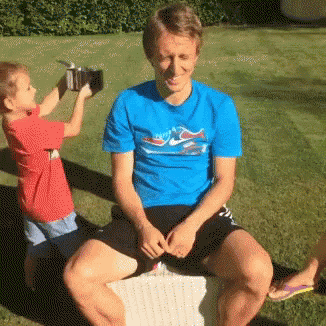 Man In Blue Dolphin Shirt Next To Boy GIF
