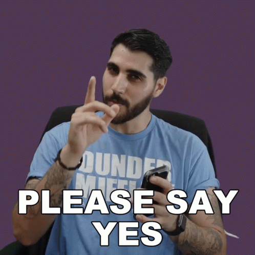 Man in Blue Dundee Mifflin Shirt Holding Cell Phone Saying Please Say Yes