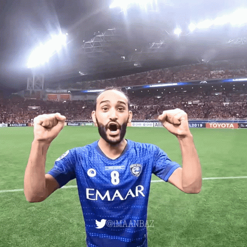 Man in Blue Emaar Jersey on Soccer Field