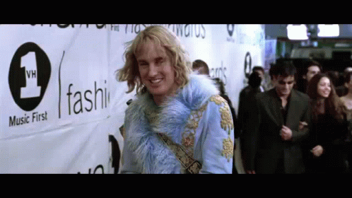 Man in Blue Fur Coat with Music First Sign
