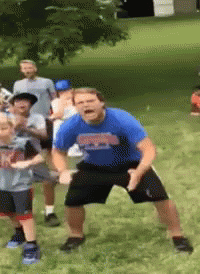 Man in Blue Georgia Shirt Dancing on Grass