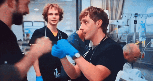 Man In Blue Gloves Talking In Hospital GIF