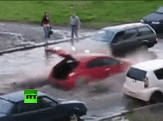 Man In Blue Hard Hat By Flooding Pipe GIF