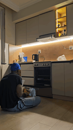 Man in Blue Hard Hat Fixing Kitchen Appliance