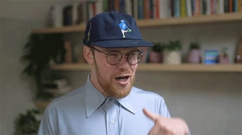 Man In Blue Hat And Glasses Pointing GIF