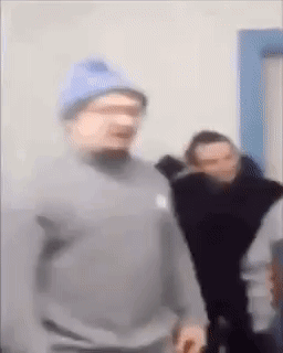 Man in Blue Hat and Gray Sweatshirt