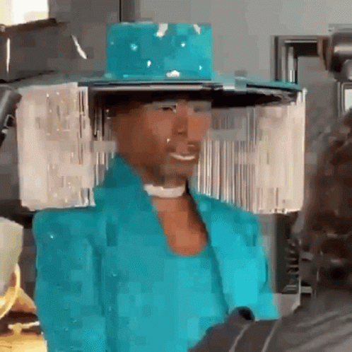 Man in Blue Hat and Jacket Smiling