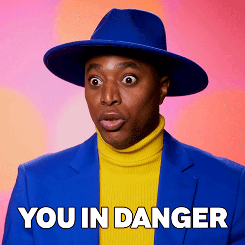 Man in Blue Hat and Yellow Turtleneck Saying You in Danger