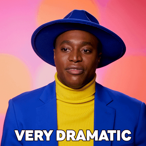 Man in Blue Hat and Yellow Turtleneck Very Dramatic