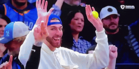 Man in Blue Hat Holding Yellow Ball