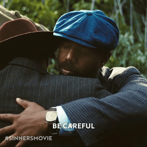 Man in Blue Hat Hugging